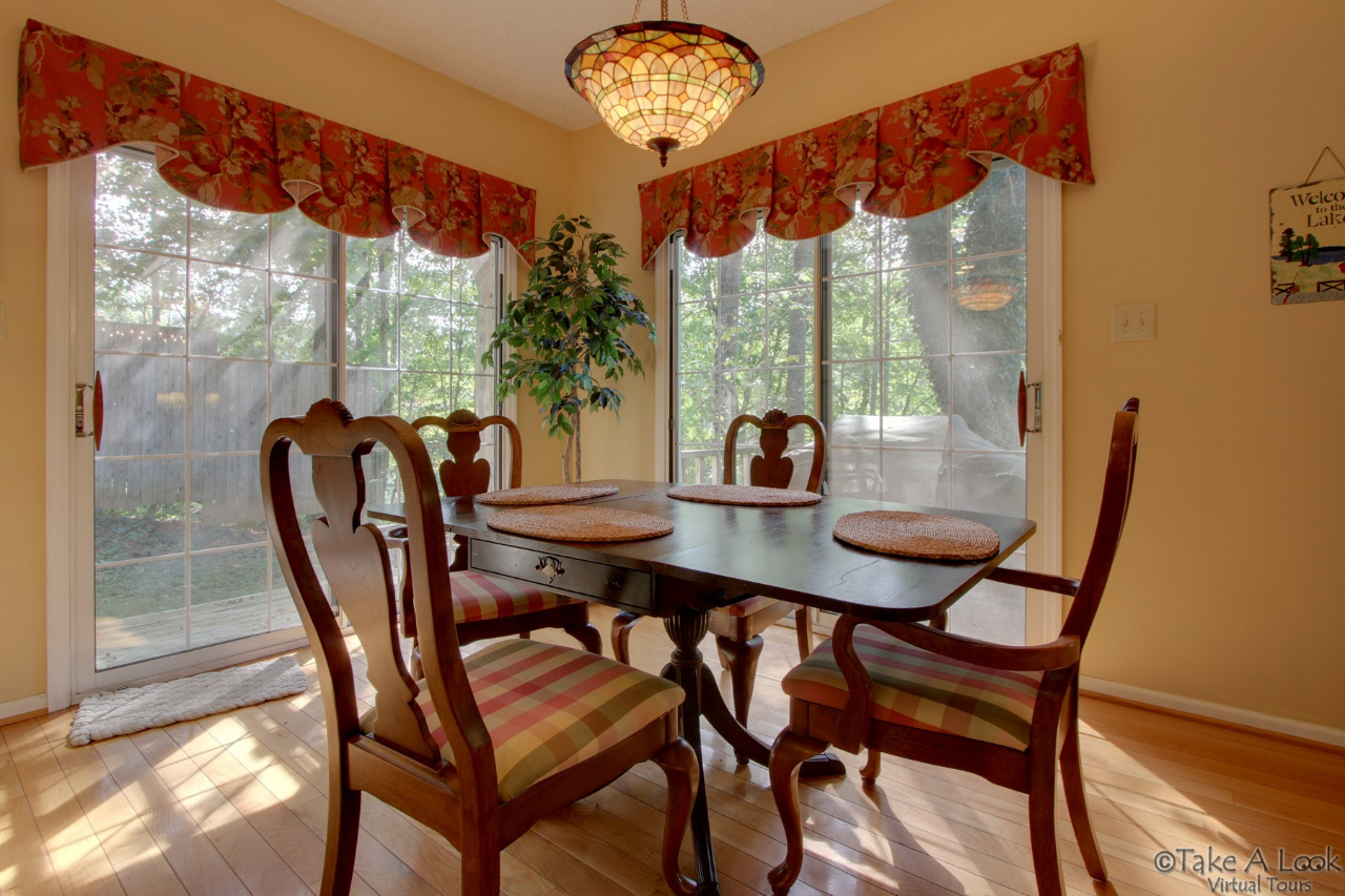 1283 Crosswind Road Goodview, VA 24095 - Photo 17 of 48 a view of a dining room with furniture a chandelier and a large window