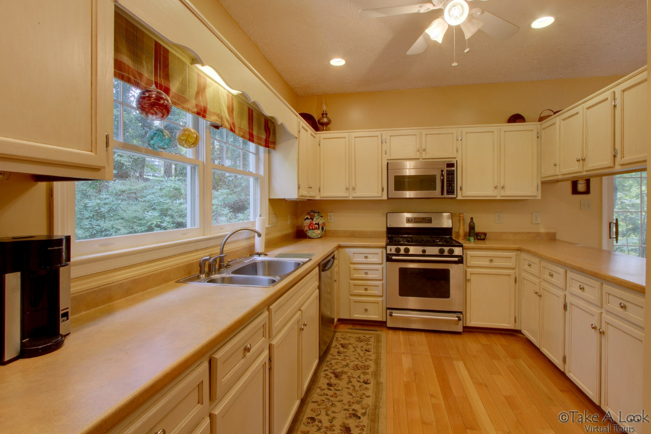 1283 Crosswind Road Goodview, VA 24095 - Photo 19 of 48 a kitchen with stainless steel appliances granite countertop a sink and a stove