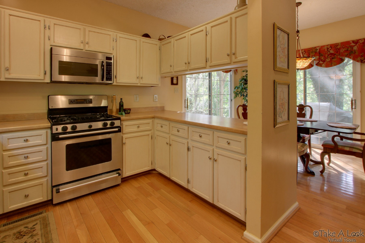 1283 Crosswind Road Goodview, VA 24095 - Photo 20 of 48 a kitchen with stainless steel appliances white cabinets and a stove top oven