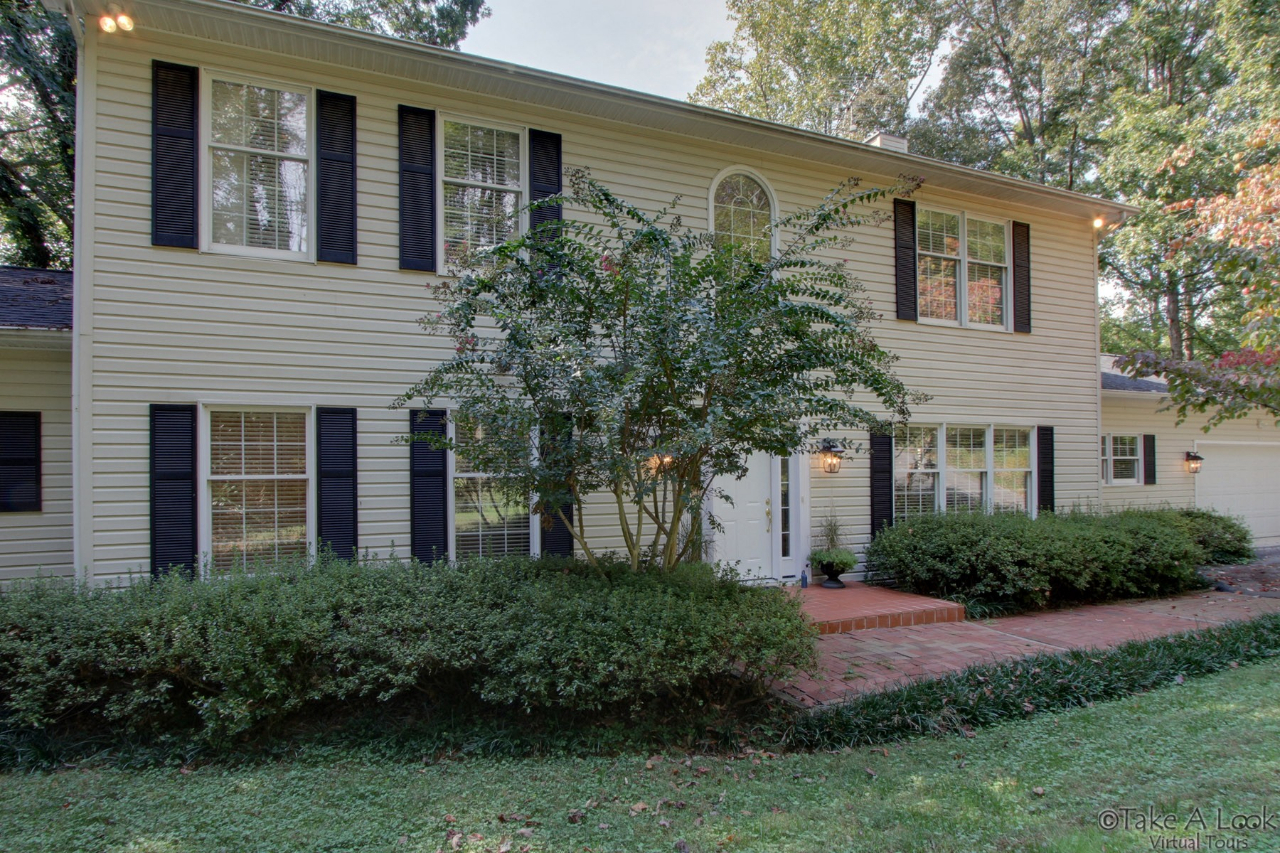 1283 Crosswind Road Goodview, VA 24095 - Photo 3 of 48 a front view of a house with a garden