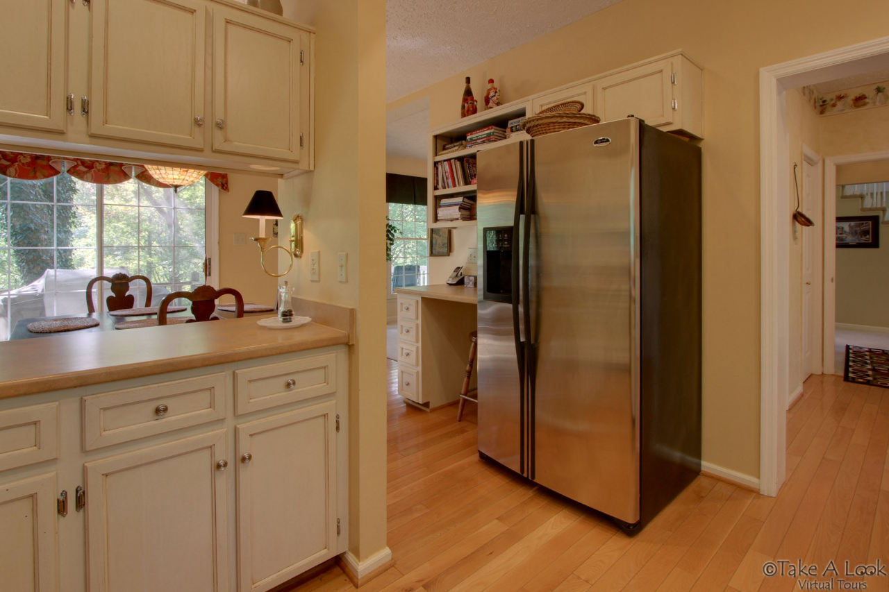 1283 Crosswind Road Goodview, VA 24095 - Photo 21 of 48 a kitchen with stainless steel appliances a refrigerator sink and cabinets