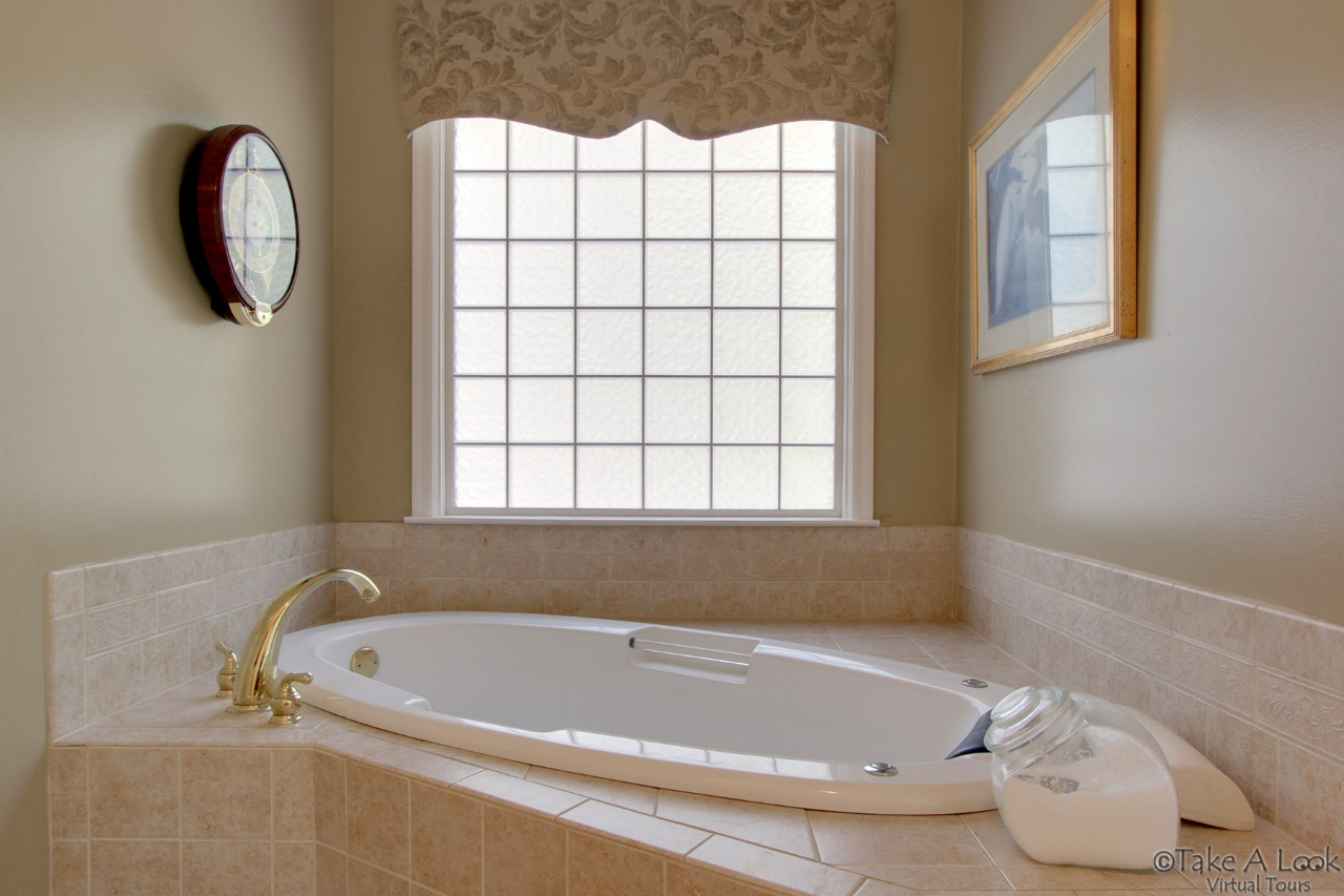 1283 Crosswind Road Goodview, VA 24095 - Photo 27 of 48 a bathroom with a tub and a window