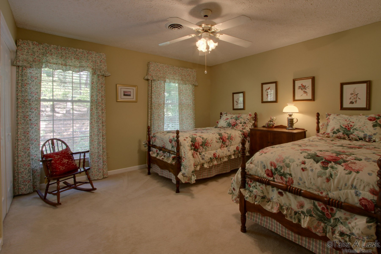1283 Crosswind Road Goodview, VA 24095 - Photo 31 of 48 a spacious bedroom with two beds and painting on the wall