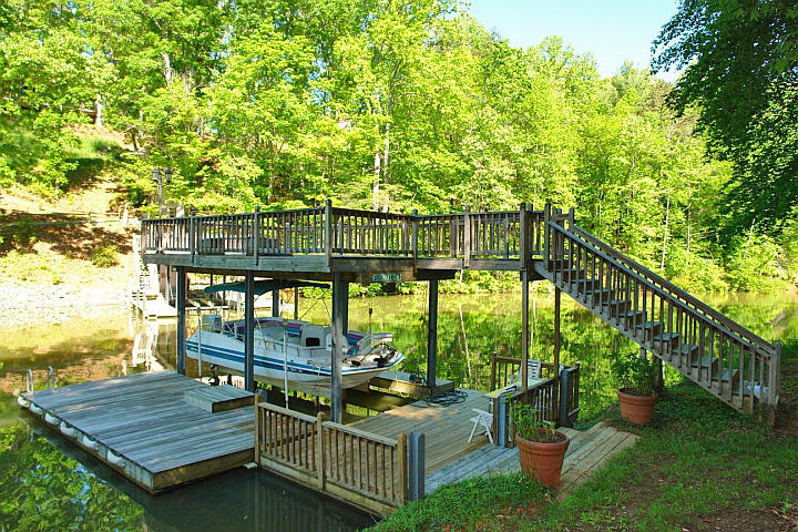 1283 Crosswind Road Goodview, VA 24095 - Photo 39 of 48 a view of a balcony with chairs and wooden fence