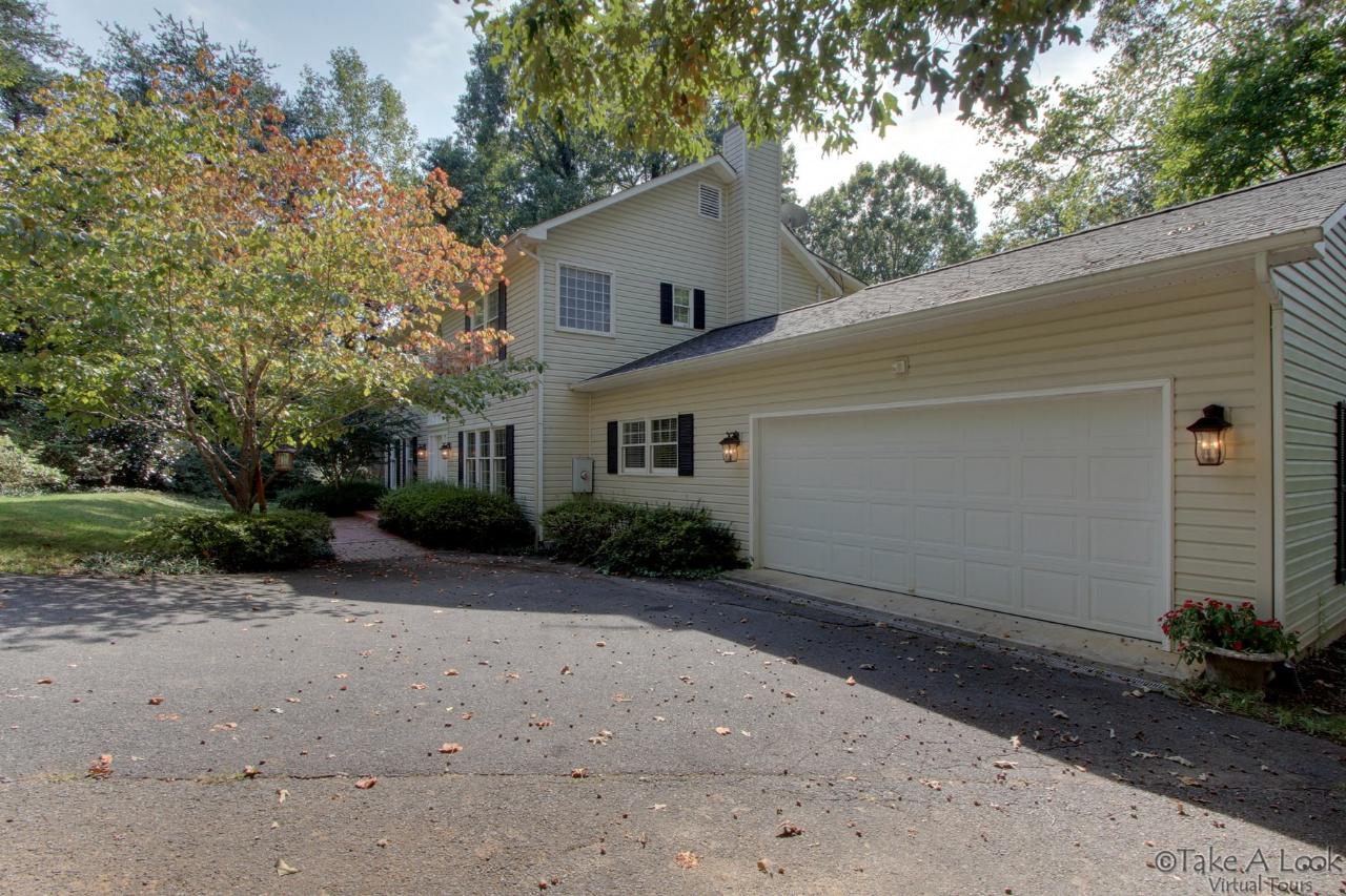 1283 Crosswind Road Goodview, VA 24095 - Photo 6 of 48 a front view of a house with a yard and a garage