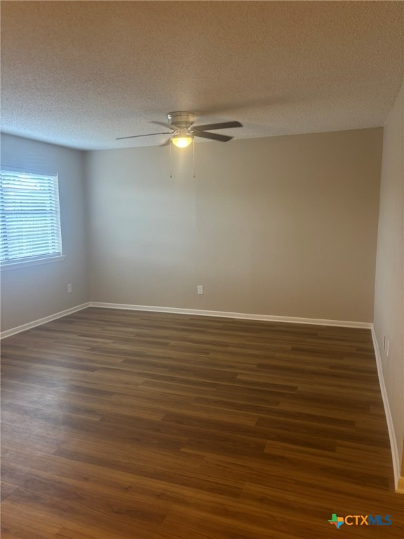 104 Milann Street Victoria, TX 77901 - Photo 2 of 10 a view of an empty room with wooden floor and windows