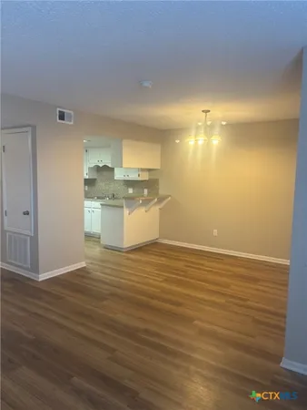 a view of a room with wooden floor
