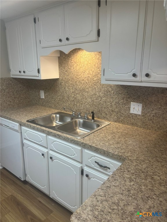 104 Milann Street Victoria, TX 77901 - Photo 5 of 10 a kitchen with granite countertop white cabinets and sink