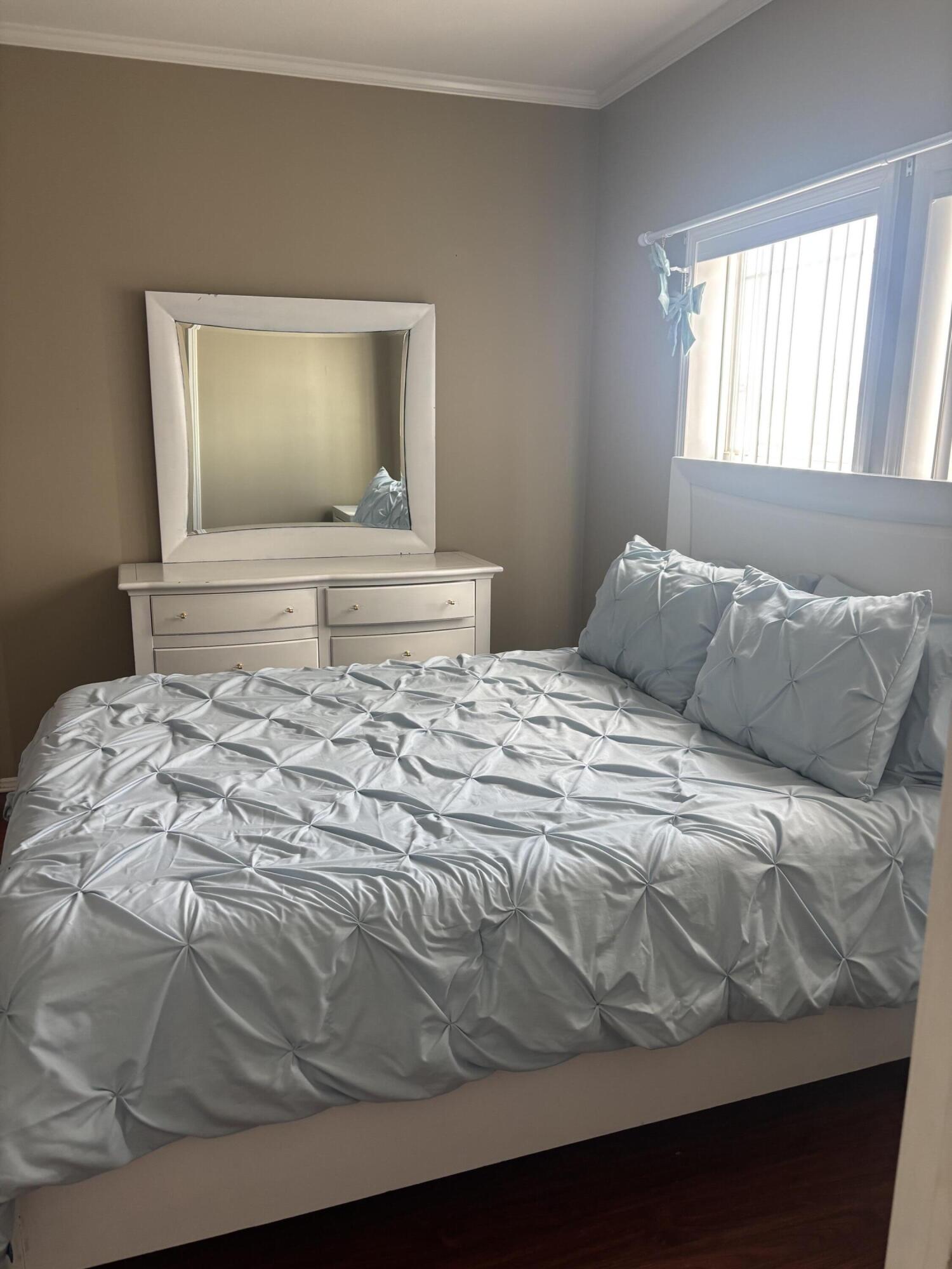 210 West 2nd Court Key Largo, FL 33037 - Photo 13 of 30 a bedroom with a bed and a window