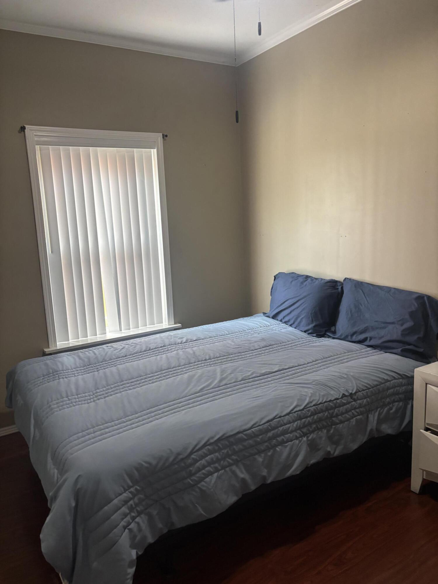 210 West 2nd Court Key Largo, FL 33037 - Photo 16 of 30 a bedroom with a bed next to a window