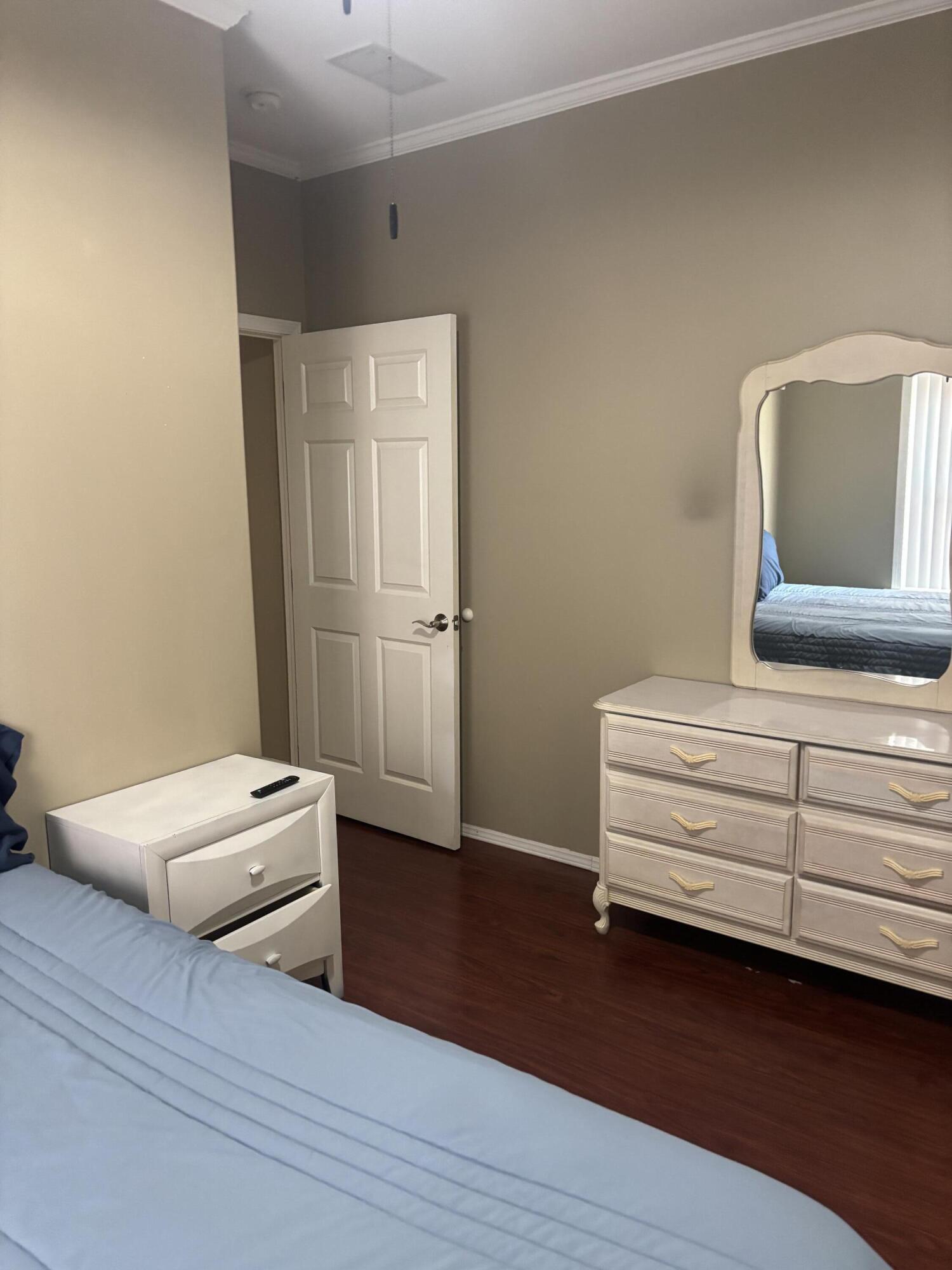 210 West 2nd Court Key Largo, FL 33037 - Photo 23 of 30 a room with a chair and wooden floor