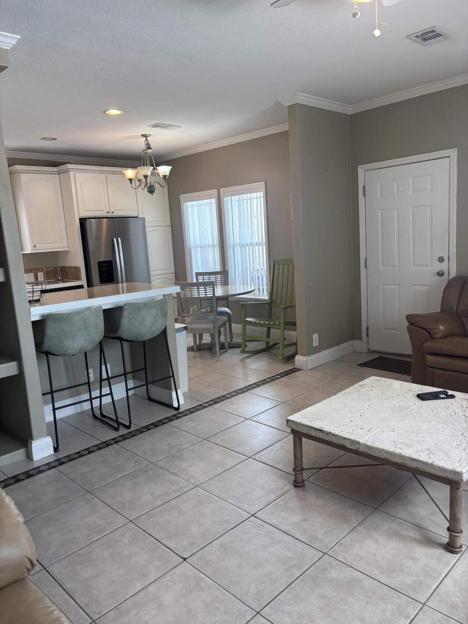 210 West 2nd Court Key Largo, FL 33037 - Photo 8 of 30 a living room with furniture a rug and gym equipment
