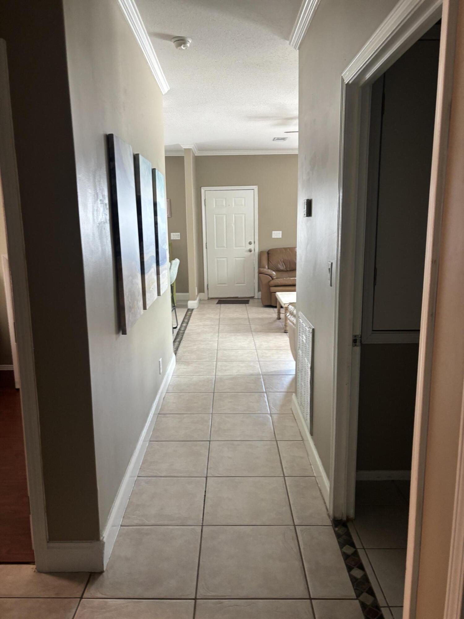 210 West 2nd Court Key Largo, FL 33037 - Photo 9 of 30 a view of a hallway with wooden floor and a bathroom