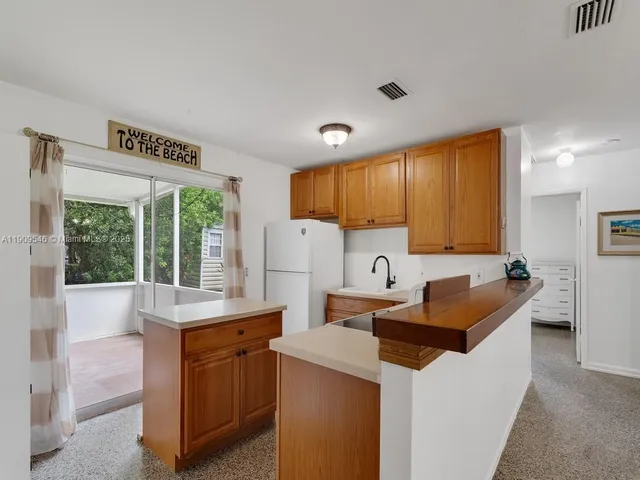 a kitchen that has a sink and a stove in it