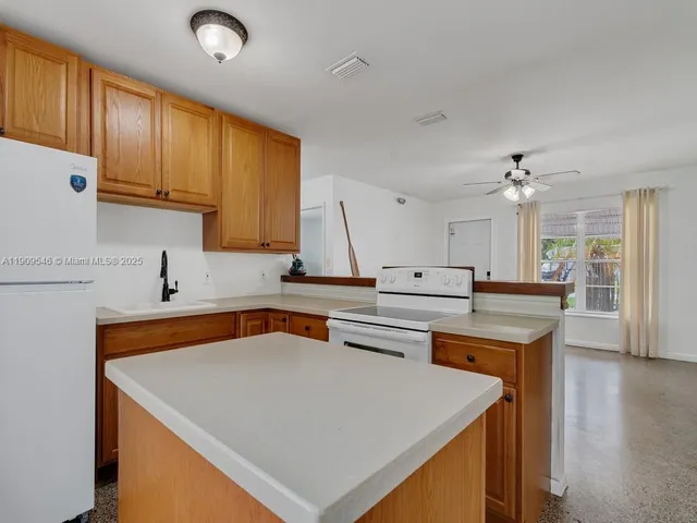 a kitchen with a sink a stove and cabinets