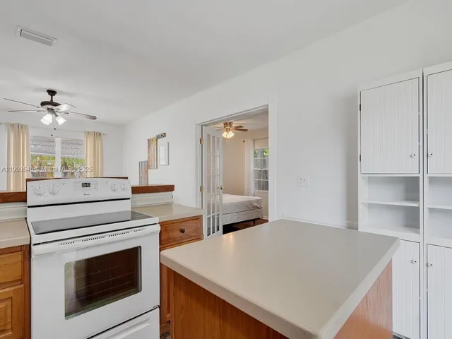 a kitchen with a stove cabinets and wooden floor