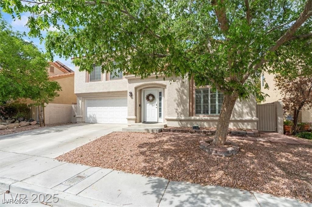 9416 Rolling Ridge Lane Las Vegas, NV 89134 - Photo 3 of 34 View of front of home featuring concrete driveway, a garage, and stucco siding