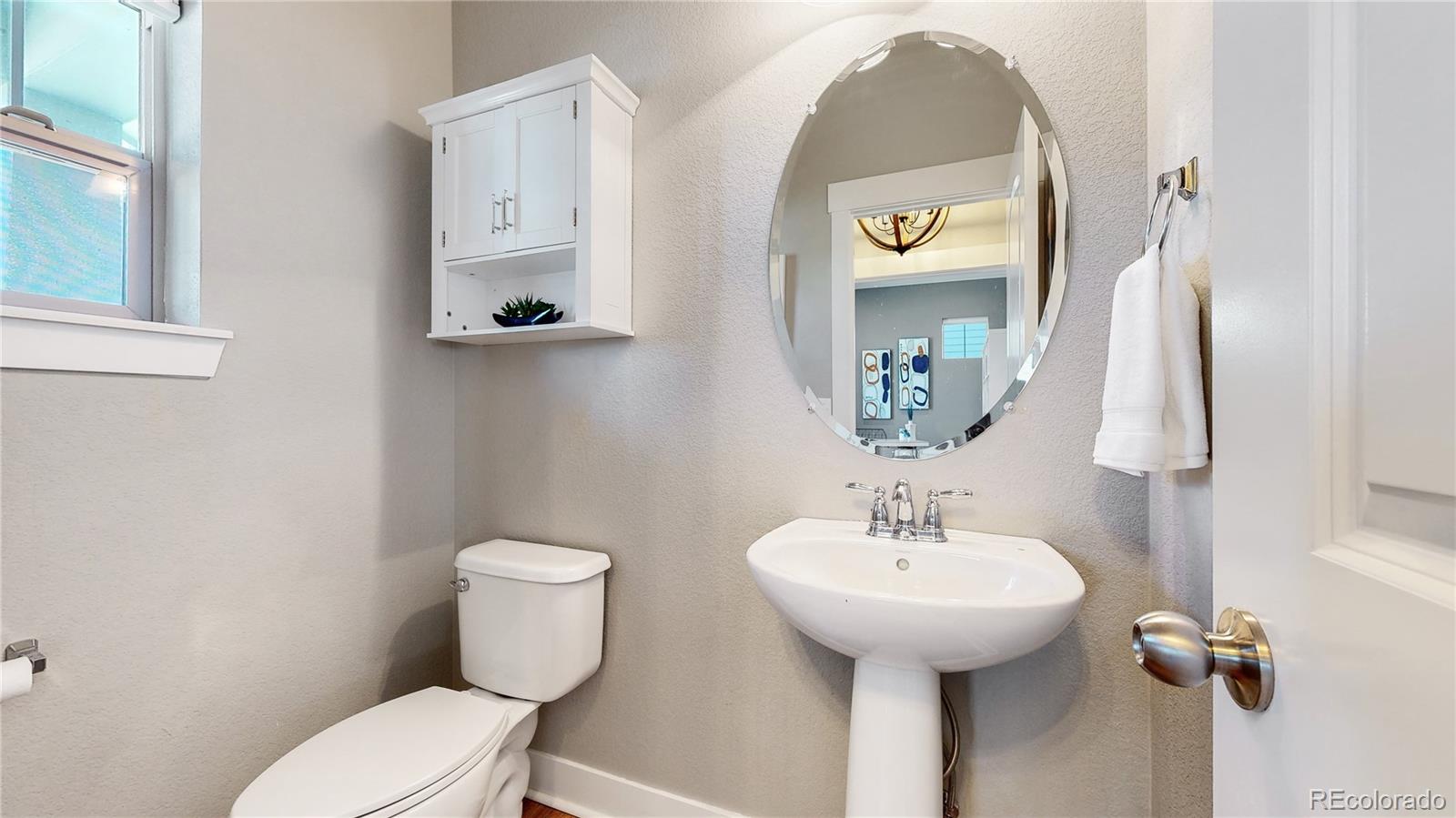 8728 54th Place Denver, CO 80238 - Photo 12 of 35 a bathroom with a toilet sink and mirror