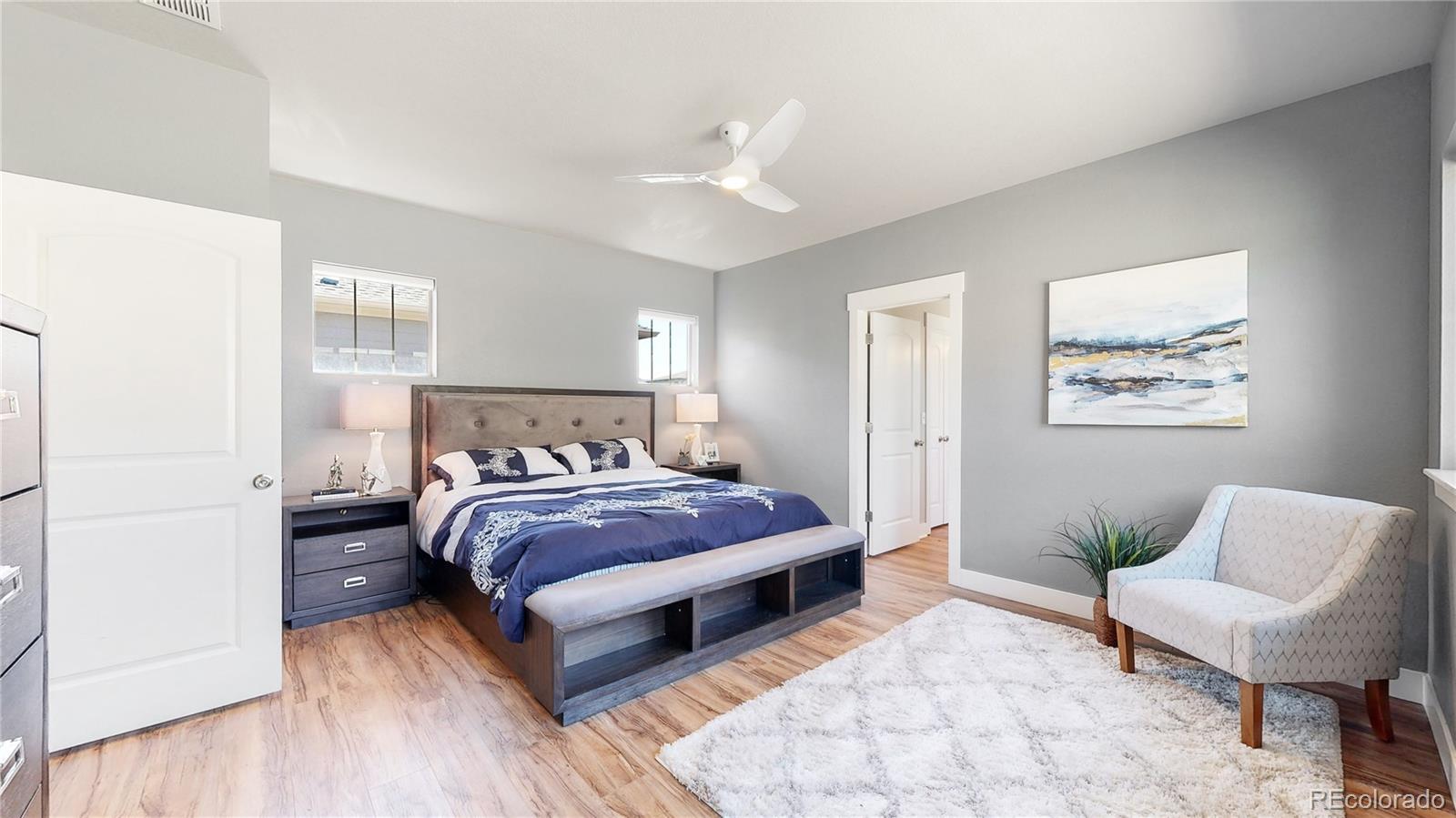 8728 54th Place Denver, CO 80238 - Photo 13 of 35 a spacious bedroom with a bed and a couch