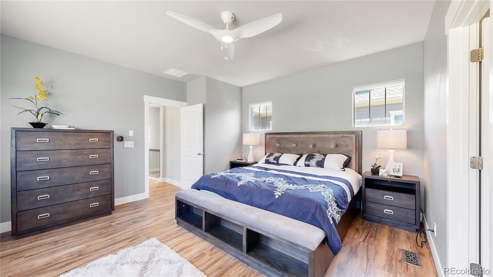 8728 54th Place Denver, CO 80238 - Photo 14 of 35 a bedroom with a bed and a dresser