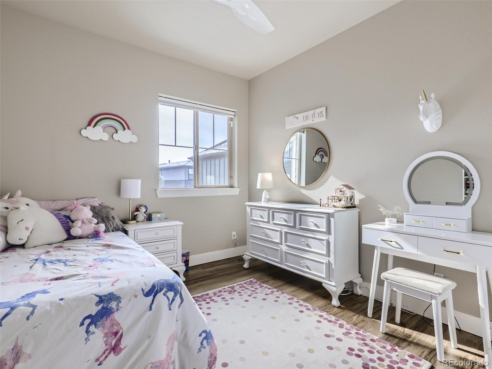 8728 54th Place Denver, CO 80238 - Photo 19 of 35 a bedroom with a bed window and a dresser