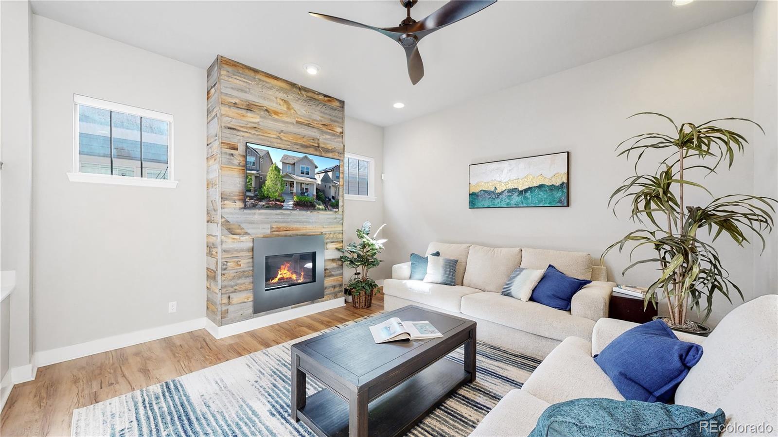 8728 54th Place Denver, CO 80238 - Photo 2 of 35 a living room with furniture and a fireplace