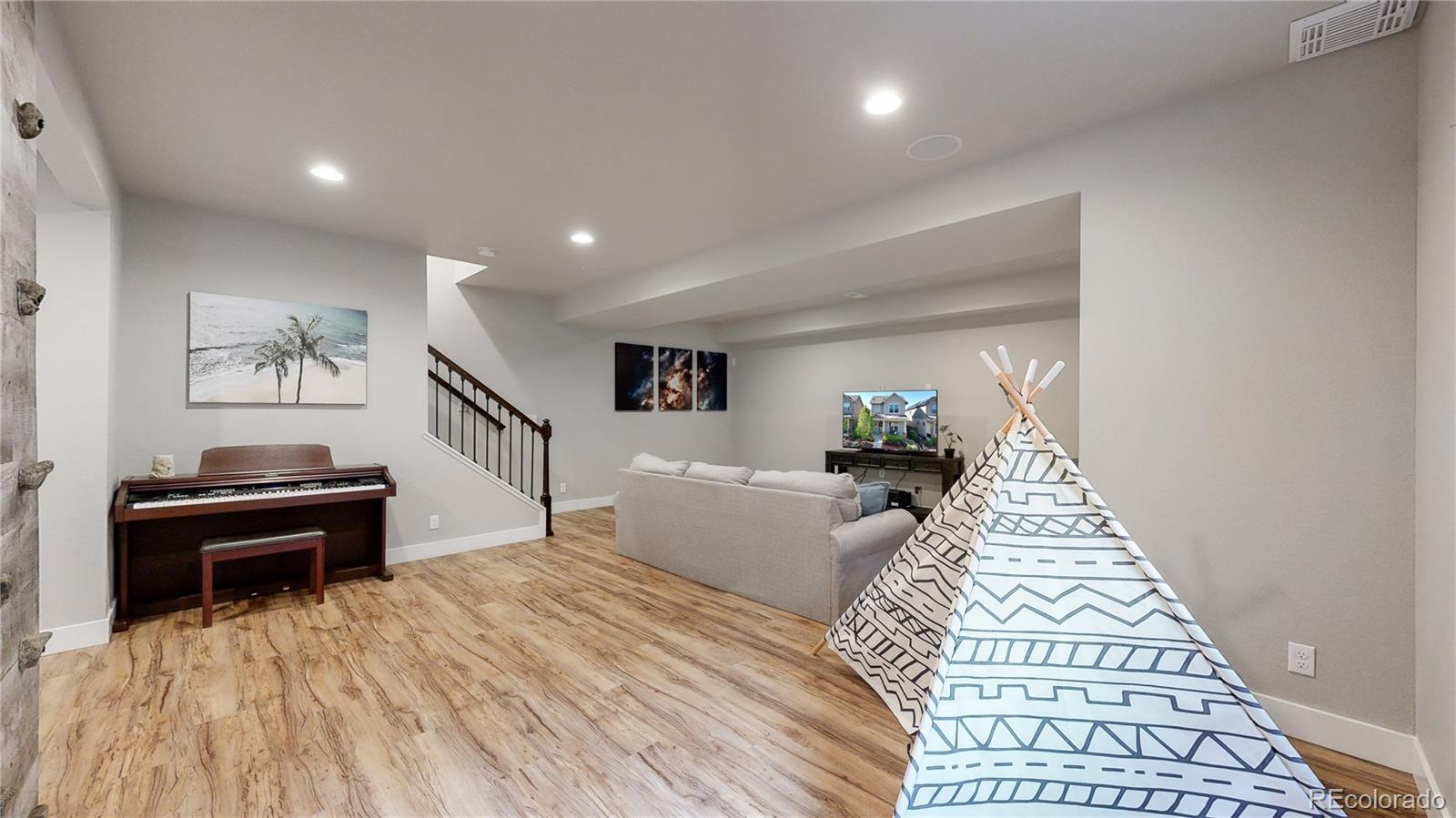 8728 54th Place Denver, CO 80238 - Photo 22 of 35 a living room with furniture and a piano