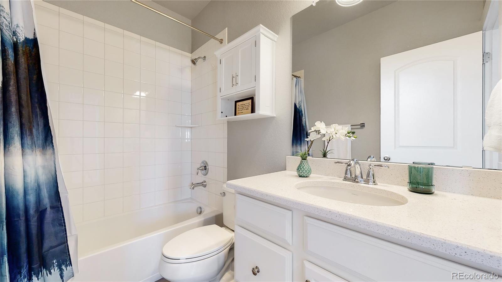 8728 54th Place Denver, CO 80238 - Photo 25 of 35 a bathroom with a sink a toilet and shower