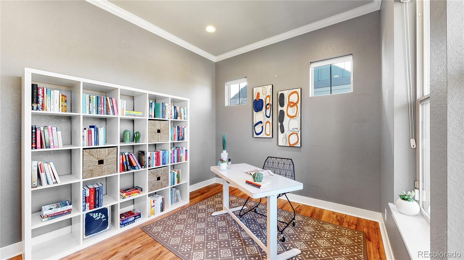 8728 54th Place Denver, CO 80238 - Photo 7 of 35 a workspace with furniture and a book shelf