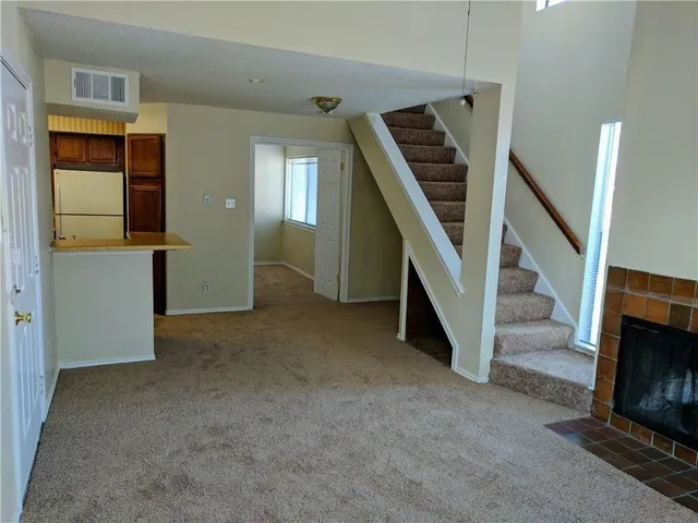 a view of hallway with livingroom and stairs