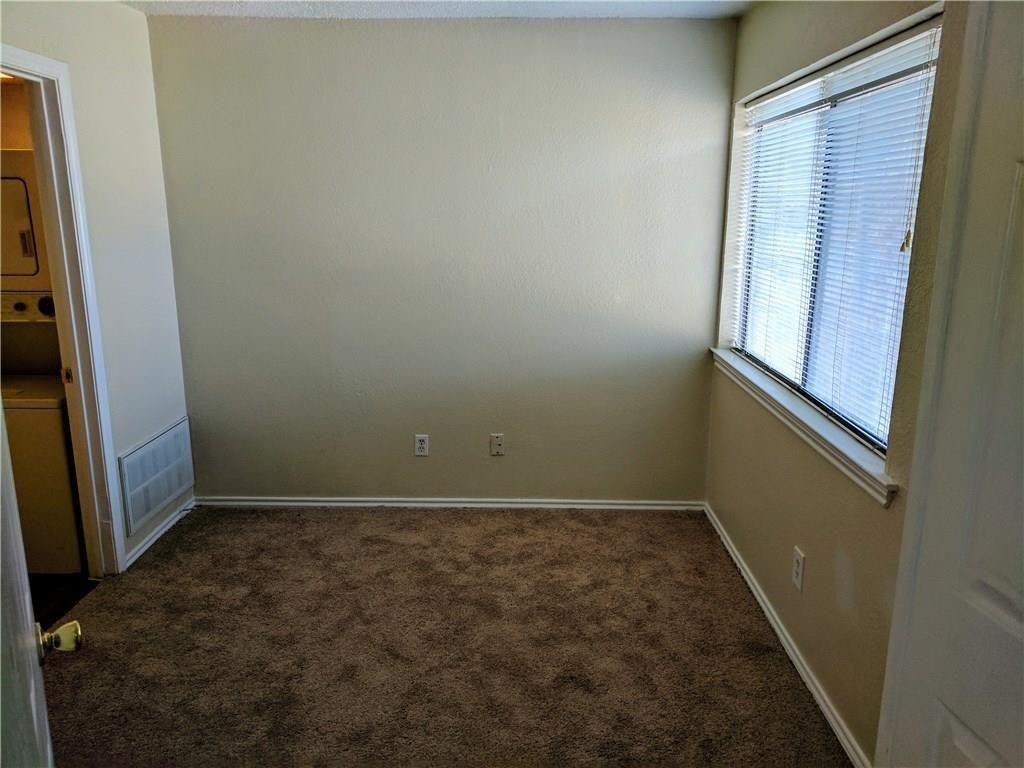 9803 Walnut Street, Unit 212 Dallas, TX 75243 - Photo 4 of 10 a view of room with window and hardwood floor
