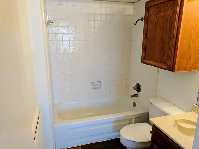 a bathroom with a sink a toilet and bathtub