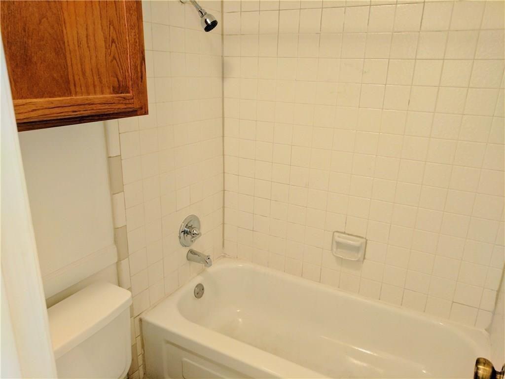 9803 Walnut Street, Unit 212 Dallas, TX 75243 - Photo 8 of 10 a bathroom with a bathtub and shower