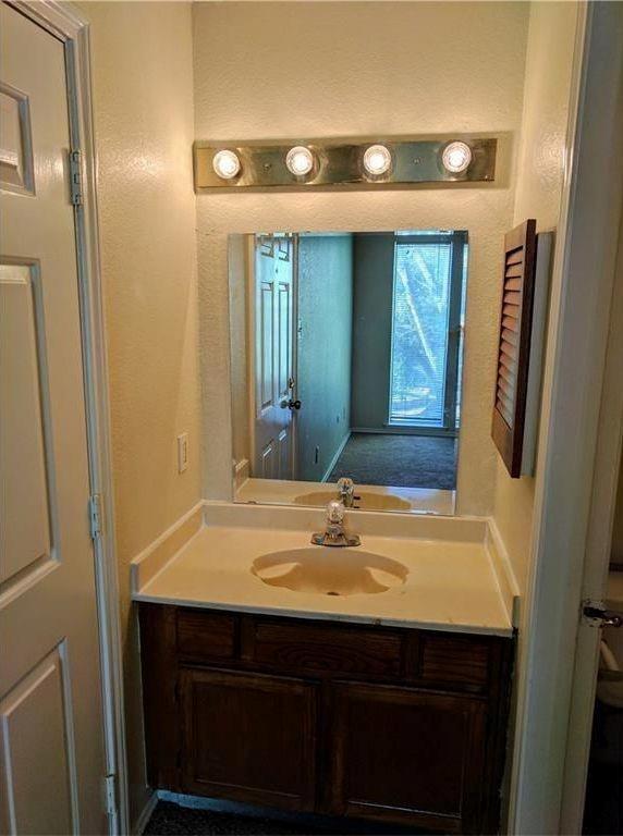 9803 Walnut Street, Unit 212 Dallas, TX 75243 - Photo 10 of 10 a bathroom with a sink and a mirror