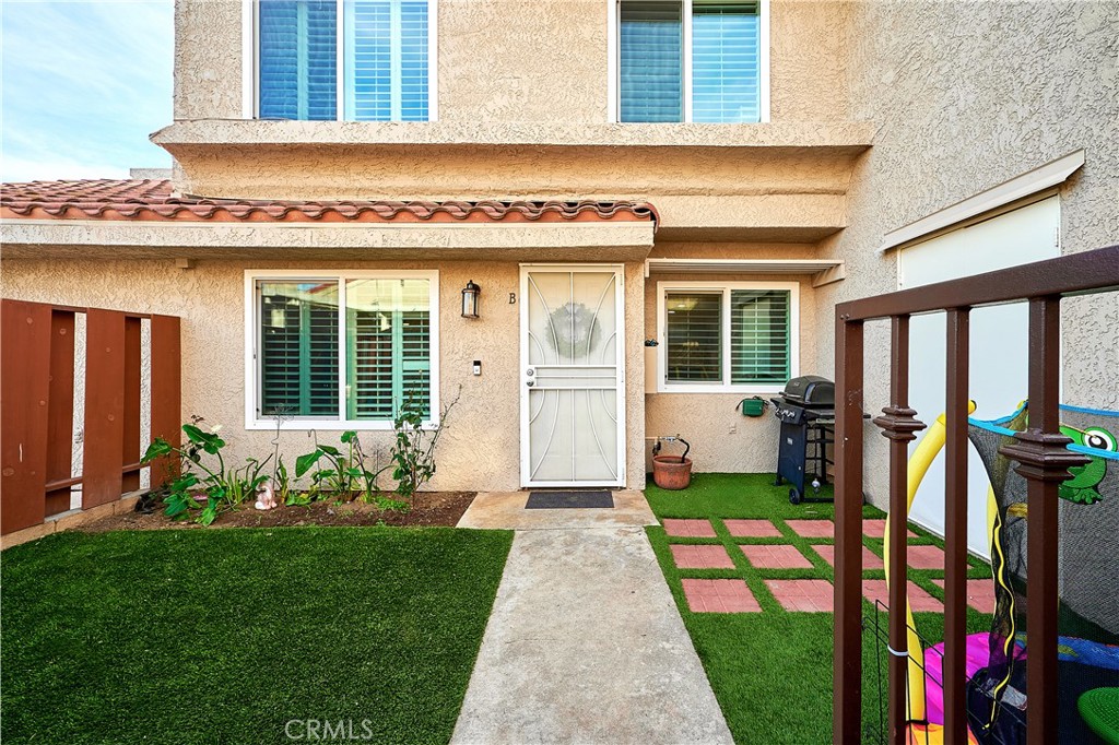 6949 Laguna Place, Unit B1 Rancho Cucamonga, CA 91701 - Photo 1 of 20 a front view of a house with garden