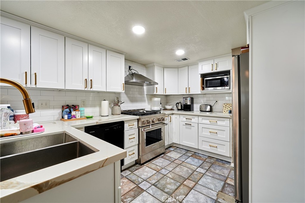 6949 Laguna Place, Unit B1 Rancho Cucamonga, CA 91701 - Photo 11 of 20 a kitchen with a stove sink and a refrigerator