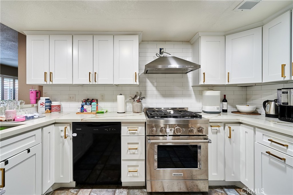 6949 Laguna Place, Unit B1 Rancho Cucamonga, CA 91701 - Photo 12 of 20 a kitchen with stainless steel appliances granite countertop a stove and white cabinets