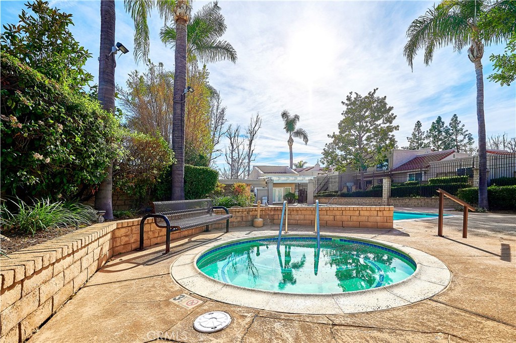 6949 Laguna Place, Unit B1 Rancho Cucamonga, CA 91701 - Photo 18 of 20 a view of a swimming pool with a lounge chairs