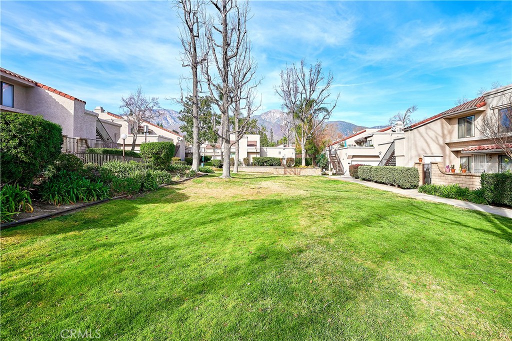 6949 Laguna Place, Unit B1 Rancho Cucamonga, CA 91701 - Photo 20 of 20 a view of a house with a big yard and fountain