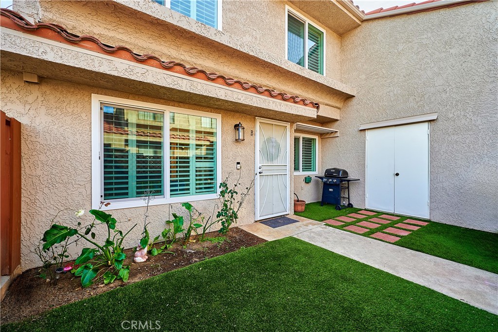 6949 Laguna Place, Unit B1 Rancho Cucamonga, CA 91701 - Photo 2 of 20 a front view of a house with garden