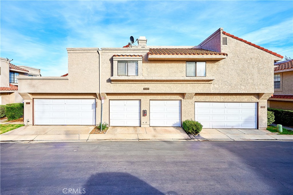 6949 Laguna Place, Unit B1 Rancho Cucamonga, CA 91701 - Photo 5 of 20 a front view of a house with a yard and garage