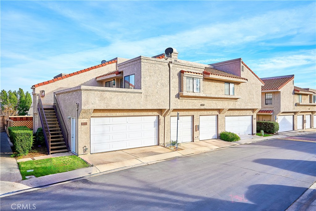 6949 Laguna Place, Unit B1 Rancho Cucamonga, CA 91701 - Photo 6 of 20 a view of a white house with a street