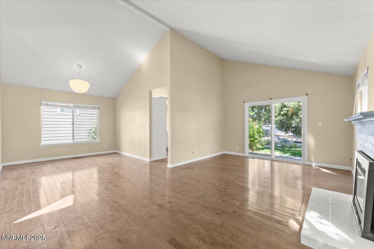 7187 Blue Falls Circle Reno, NV 89511 - Photo 11 of 42 an empty room with wooden floor and windows