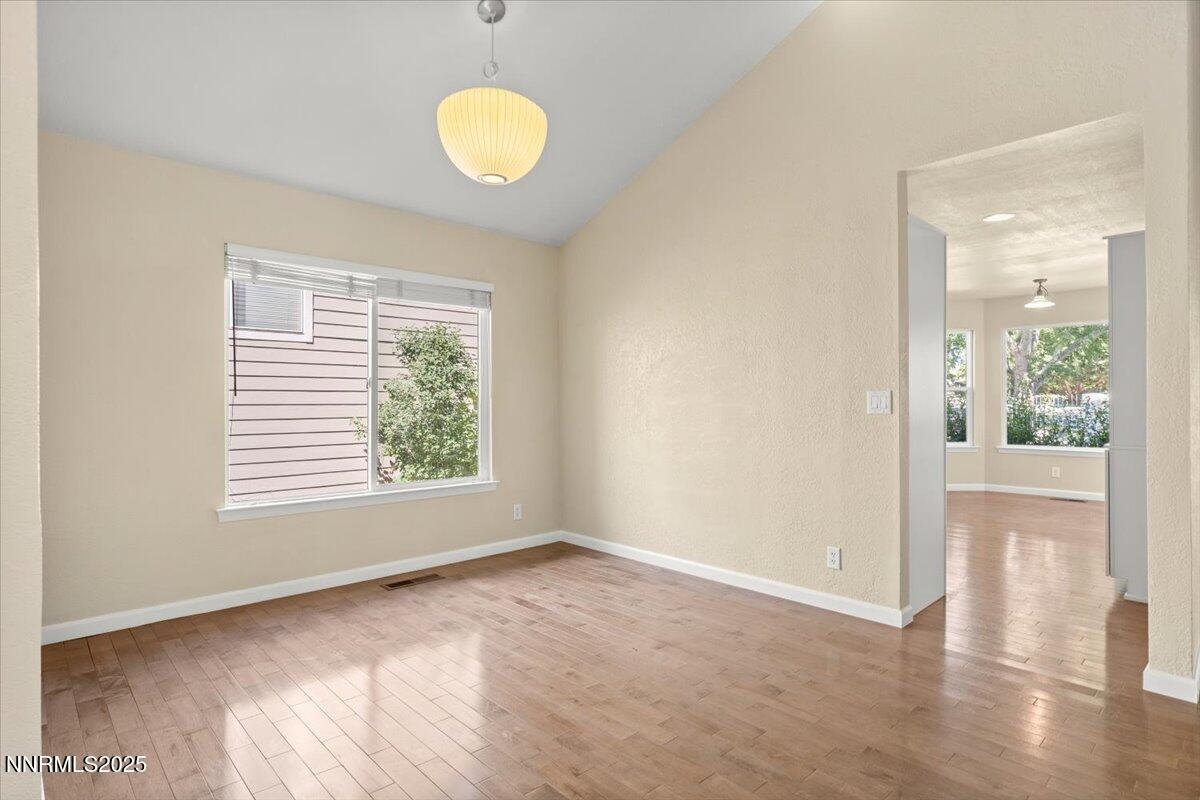 7187 Blue Falls Circle Reno, NV 89511 - Photo 14 of 42 a view of an empty room with wooden floor and a window