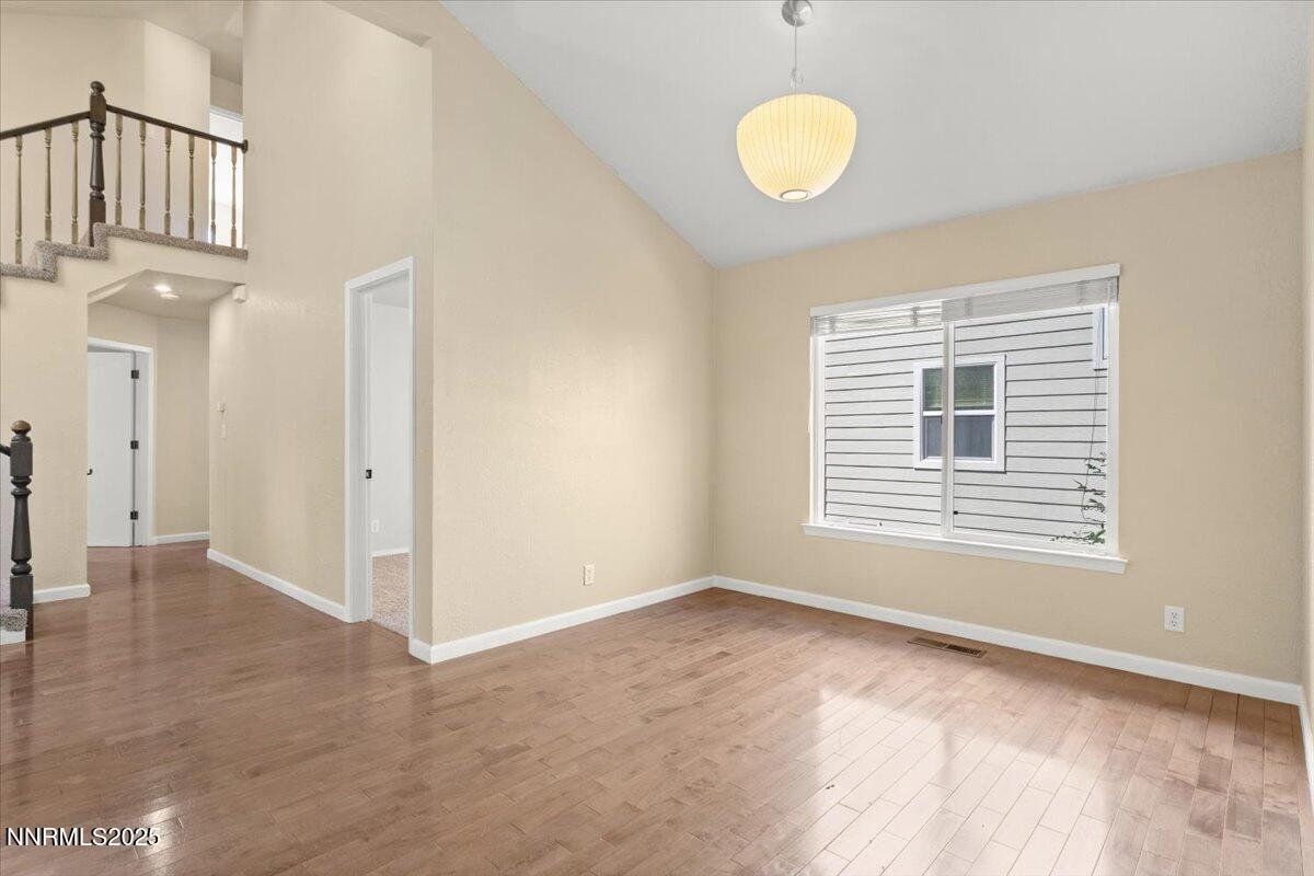 7187 Blue Falls Circle Reno, NV 89511 - Photo 15 of 42 a view of an empty room with wooden floor and a window