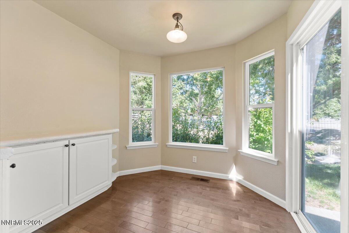 7187 Blue Falls Circle Reno, NV 89511 - Photo 19 of 42 wooden floor in an empty room with a window