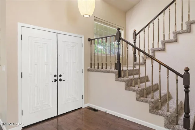 a view of entryway with wooden floor and stairs