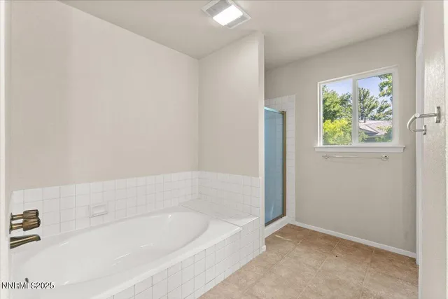 a bathroom with bathtub and window