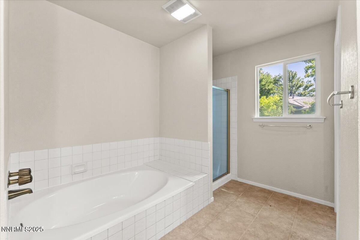7187 Blue Falls Circle Reno, NV 89511 - Photo 27 of 42 a bathroom with bathtub and window