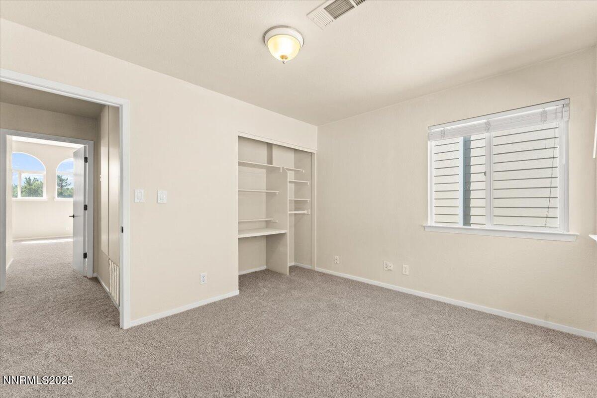 7187 Blue Falls Circle Reno, NV 89511 - Photo 30 of 42 an empty room with windows and closet